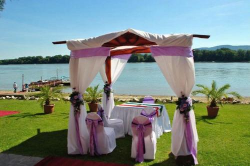 a gazebo with a table and chairs under it at Camelot Club Hotel in Vác
