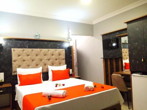 a bedroom with a large bed with orange pillows at Roomsin Sultanahmet in Istanbul
