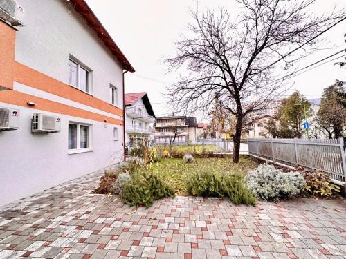 a garden in the middle of a building with a tree at Villa Max in Sarajevo
