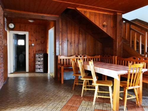 a dining room with a wooden table and chairs at Drevenica Spanka in Špania Dolina