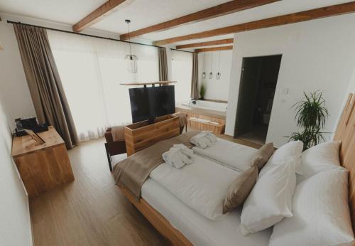 a large white bed in a room with a television at Zemunice Knezevic in Banja Luka