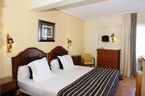 Säng eller sängar i ett rum på Hotel Risco