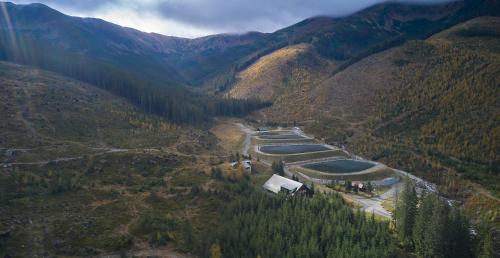 an aerial view of a river in a mountain valley at Chalety Otupné - Apartmán Lorien in Demanovska Dolina