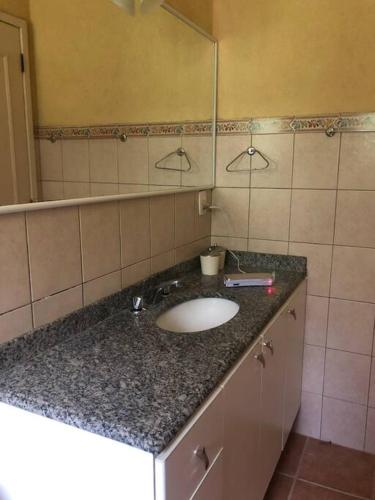 a bathroom with a sink and a mirror at Casa em Teresopolis in Teresópolis