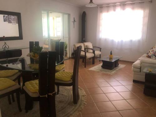 a living room with a table and chairs and a couch at Casa em Teresopolis in Teresópolis