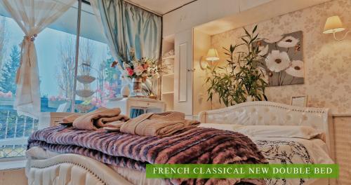 a bedroom with a bed and a large window at Villa Diva - Villa Hestia Paris 16e in Boulogne-Billancourt