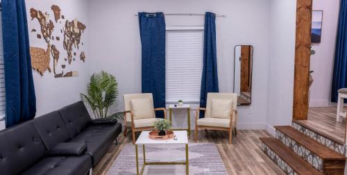a living room with a black couch and chairs at Luxury 5-BR House, Tampa Downtown with Cottage in Tampa
