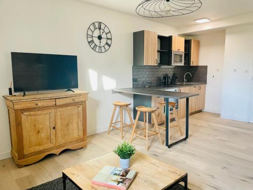 une cuisine avec une grande télévision murale dans l'établissement Style Loft Chic : T2 avec Chambre Parentale -Top Séjour Arras, à Arras