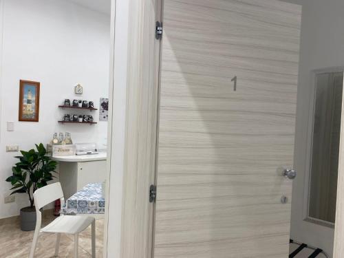 a door in a room with a chair and a table at Toledo Point in Naples