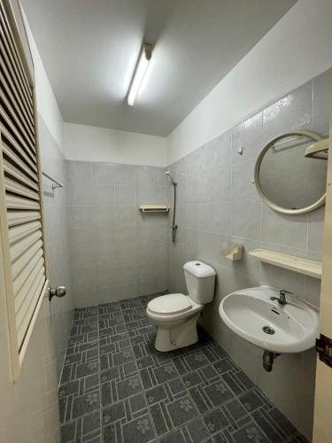 a bathroom with a toilet and a sink at Genesis Urban Phuket in Ban Lo Long