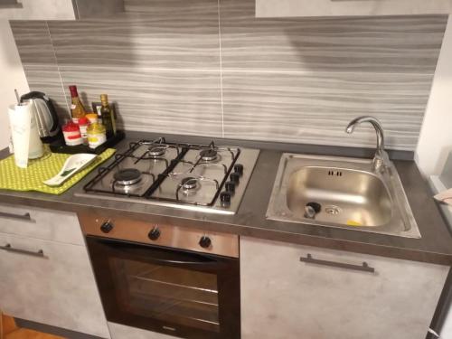 a kitchen with a stove and a sink at Montegrappa Dream in Crespano del Grappa