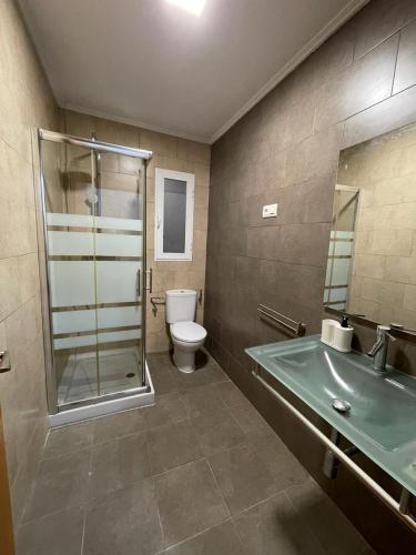 a bathroom with a shower and a toilet and a sink at UIM Mediterraneo PB Miguel Hernandez Wifi in Puerto de Sagunto