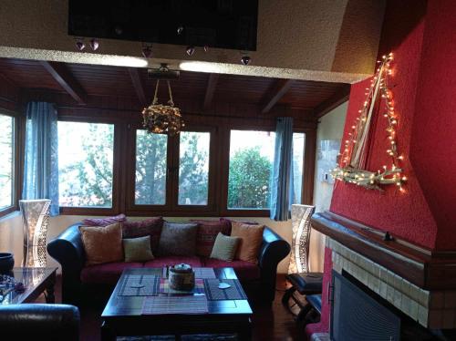 a living room with a couch and a fireplace at CHALET LE BLANC in Arachova