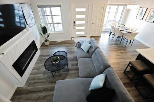 a living room with a couch and a table at Three King Beds,Central A/C,Fireplace,Park,Disney+ in Edmonton
