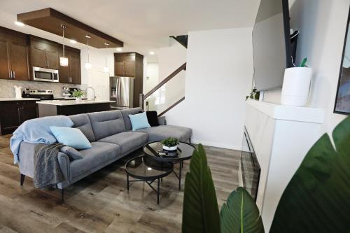 a living room with a couch and a kitchen at Three King Beds,Central A/C,Fireplace,Park,Disney+ in Edmonton