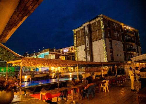 a group of people sitting at tables in front of a building at Portland Resort Hotel in Port Harcourt