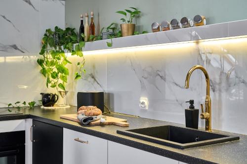 a kitchen with a sink and a counter top at Apartament Flowers - Centrum Poznania in Poznań