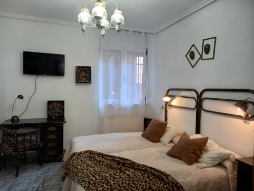 a bedroom with a bed with a cheetah blanket at EL RINCÓN DE CHAVELY in Palencia