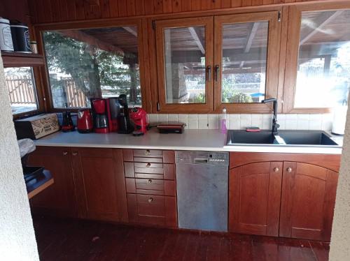 a kitchen with wooden cabinets and a sink at CHALET LE BLANC in Arachova