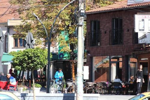 a group of people sitting outside of a building at Brickrooms apartmani in Novi Pazar