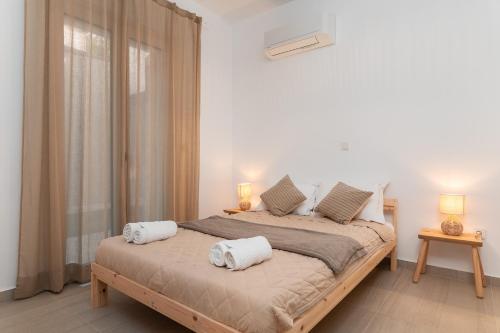 a bedroom with a bed with two towels on it at SeaView Apartment 2 in Samos