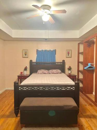 a bedroom with a bed with a ceiling fan at Island style home, low key rental in Roatan