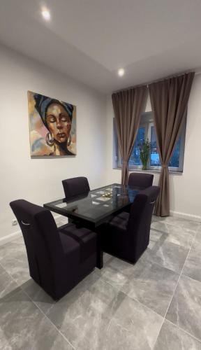 a dining room with a glass table and chairs at Apartment in Purkersdorf bei Wien Top 2 in Purkersdorf