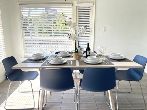 a dining room table with blue chairs around it at Lovely Home 30MIN to Berkeley, SF, Napa in Pinole