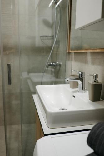 a bathroom with a sink and a shower at LILY apartment - Flexible SelfCheckins 48- Luxury- Extra big terrace with jacuzzi in Zagreb