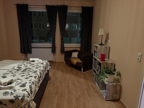 a bedroom with a bed and a chair and a window at Innenstadt Lübeck Ferienwohnung in Lübeck