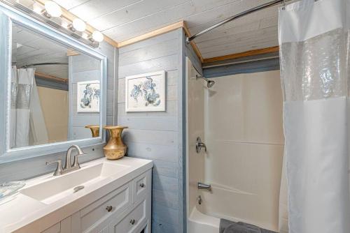 a bathroom with a sink and a shower at Something Fishy at Island Breeze of CB in Carolina Beach