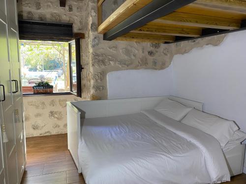 a white bed in a bedroom with a window at Vista Mora Sierra Cazorla in La Iruela