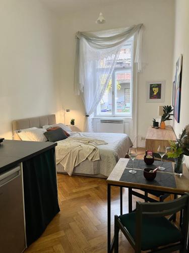 a bedroom with a bed and a table with a table at Robins Nest in The City Center in Maribor