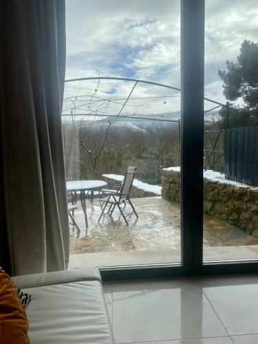 a view from a window of a patio with a table at Casa Leirón in Parada del Sil