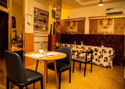a restaurant with tables and chairs in a room at Portland Resort Hotel in Port Harcourt