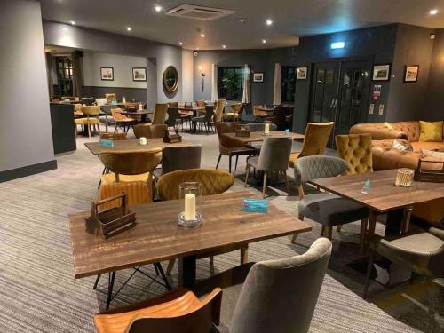 a restaurant with tables and chairs and couches at Sea view The Lookout at The Bay holiday village Filey 2 bed sleeps 5 dog friendly free leisure facilities direct beach access pub and shop click to view photos in Filey