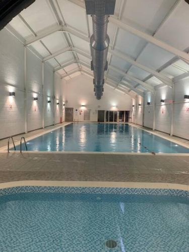 a large indoor swimming pool with a large swimming poolasteryasteryasteryasteryasteryastery at Sea view The Lookout at The Bay holiday village Filey 2 bed sleeps 5 dog friendly free leisure facilities direct beach access pub and shop click to view photos in Filey