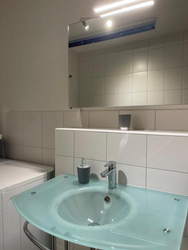a bathroom with a blue sink and a mirror at Vintage Apartment Nuremberg Old Town in Nuremberg