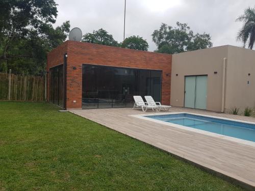 a backyard with a swimming pool and a house at Quinta El Escondido in San Bernardino