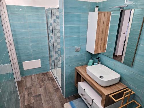 a bathroom with a sink and a mirror and a shower at Ma Maison Iris in Turin