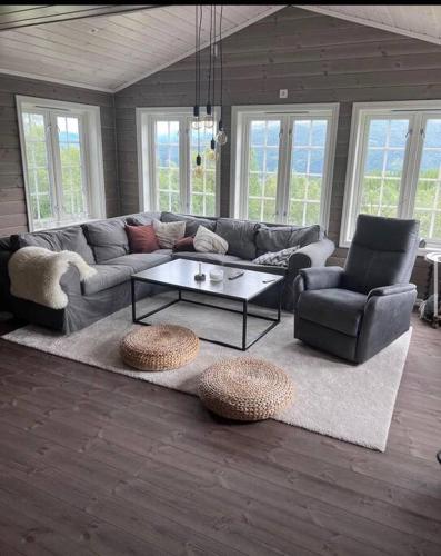 a living room with a couch and a coffee table at Koselig, nyere hytte til leie in Stranda