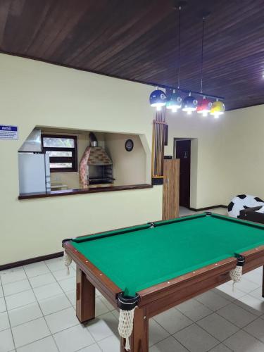 a kitchen with a pool table in a room at Apto Duplex com Mezanino in Juquei