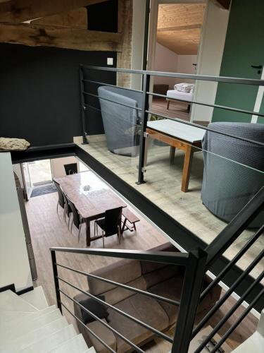 une pièce avec un escalier avec une table et des bancs dans l'établissement La Villa, à Meschers-sur-Gironde