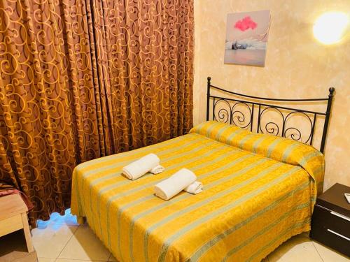 a bedroom with a bed with two pillows on it at Roma Guest House in Rome