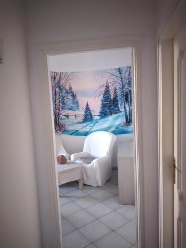 a living room with a picture of a winter scene at CasarinoLaurino Among Cinque Terre Genova And Portofino in Uscio