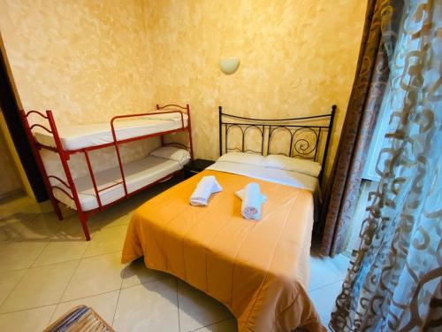 a bedroom with a bed with two towels on it at Roma Guest House in Rome