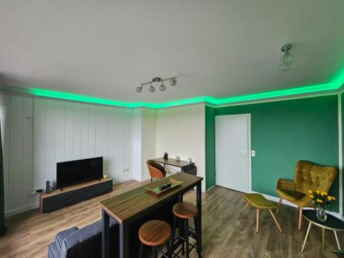 a living room with green lights on the ceilings at Sweet Home - 1 - in Moers