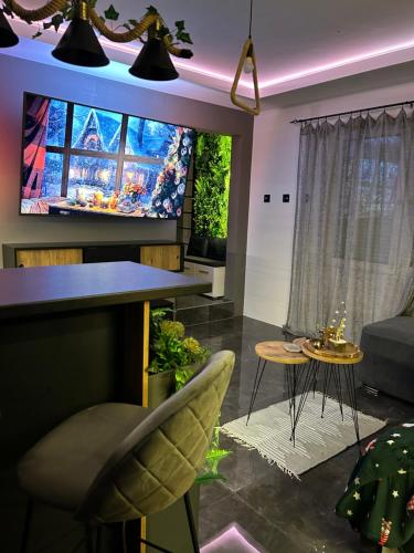 a living room with a flat screen tv on a wall at Beta Lux in Zaječar