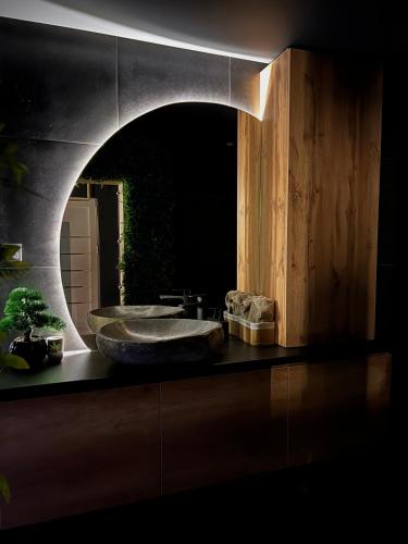 a bathroom with a sink and a large mirror at Beta Lux in Zaječar