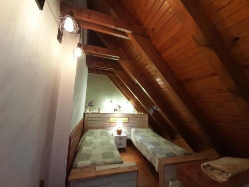 an attic room with two beds and a lamp at Dúplex Herbasabina 4 con cocina reformada in Pla de l'Ermita
